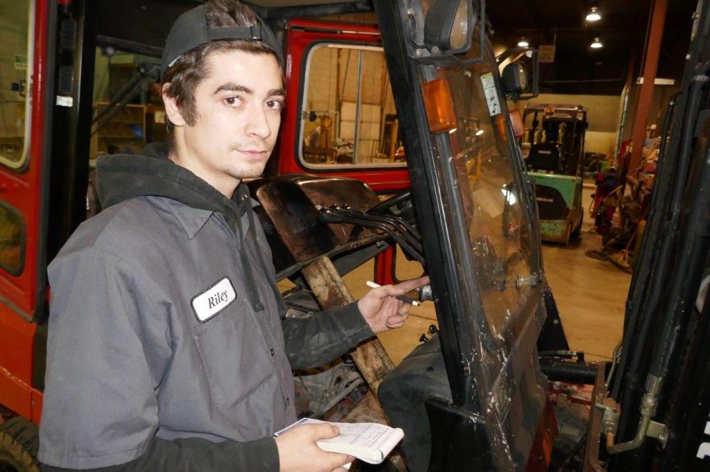 forklift operator completes daily safety checklist